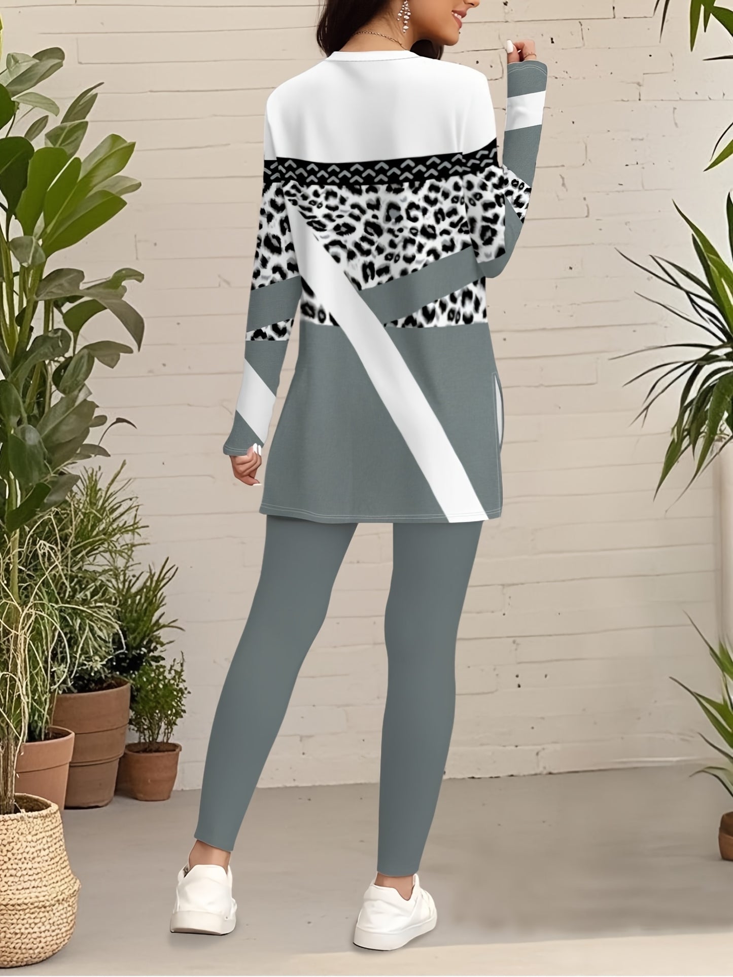 A Beautiful Women'S Outfit Featuring Geometric Patterns And Leopard Print Elements, Including a Stylish Long-Sleeve Top with Side Slits And 9-Point Fitted Pants, Perfect for Autumn.