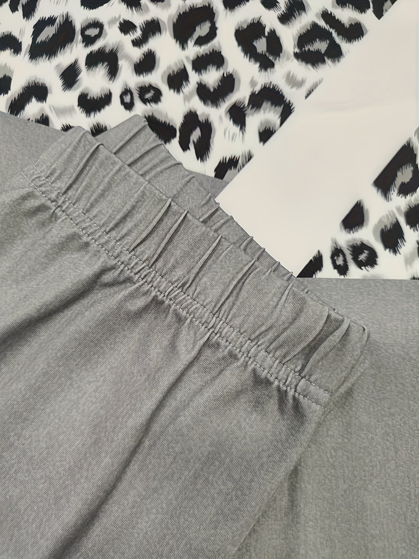 A Beautiful Women'S Outfit Featuring Geometric Patterns And Leopard Print Elements, Including a Stylish Long-Sleeve Top with Side Slits And 9-Point Fitted Pants, Perfect for Autumn.