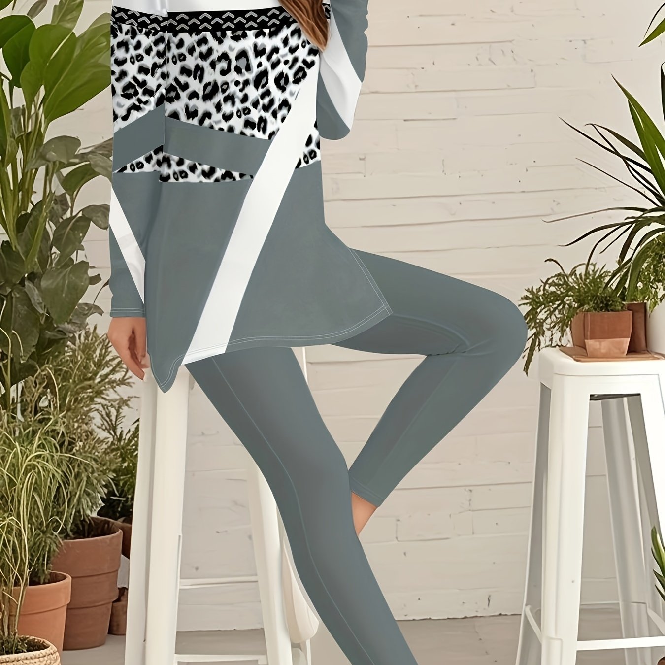 A Beautiful Women'S Outfit Featuring Geometric Patterns And Leopard Print Elements, Including a Stylish Long-Sleeve Top with Side Slits And 9-Point Fitted Pants, Perfect for Autumn.